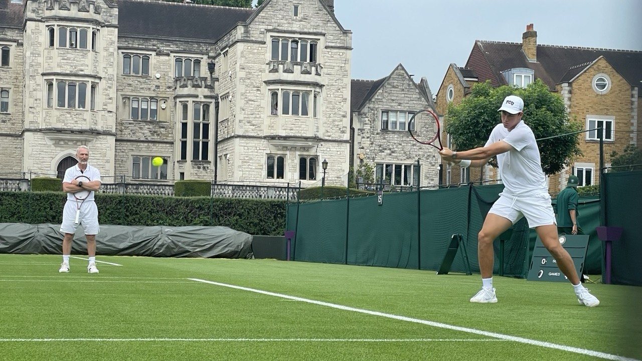 Benoit Foucher watching a player train on a grass court during the British grass-court season