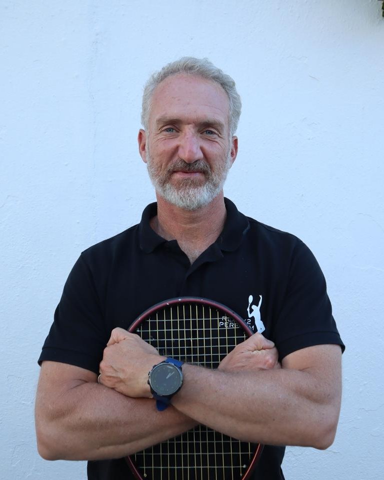 Benoit Foucher, ATP tennis coach, arms folded with his racquet